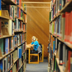 Bookshelves and student studying