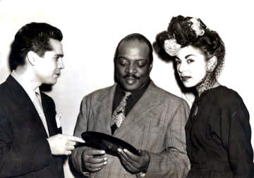 Tosti with Basie, presenting a copy of Pachuco Boogie - 1948
