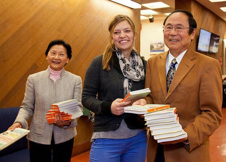 Chancellor Henry Yang and wife Dilling Yang distribute books to UCSB students