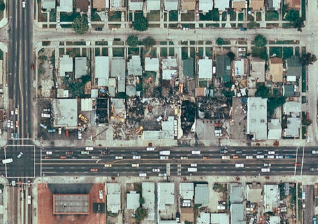A city block showing several burned buildings