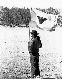 José Montoya holding the UFW flag during La Marcha de la Reconquista, 1971