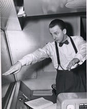 __title__ Photograph of Fletcher Markle in a booth wearing suspenders and a bow tie.