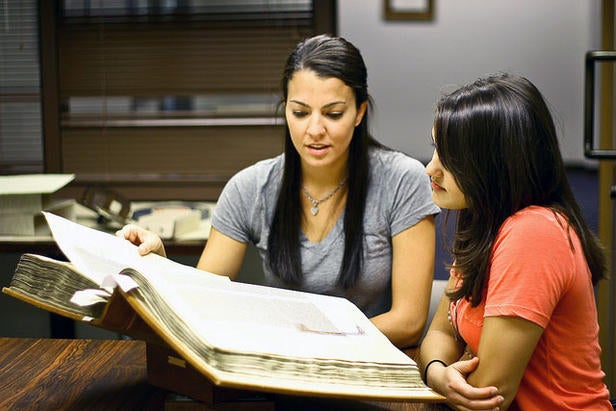 two women looking at a manuscript in Special Collections