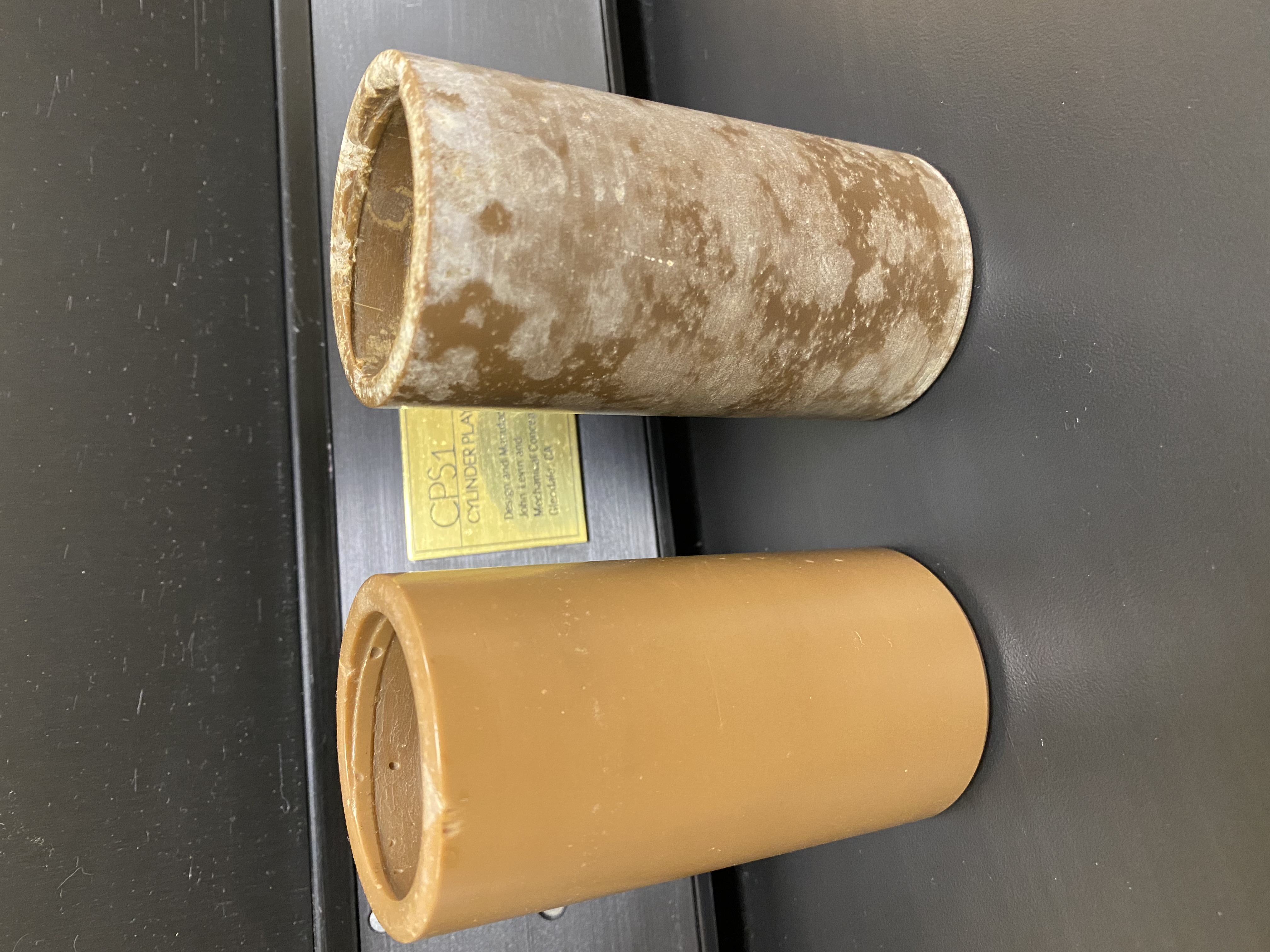 An early wax cylinder that suffered damage from improper storage (right) next to one that fared better (left).