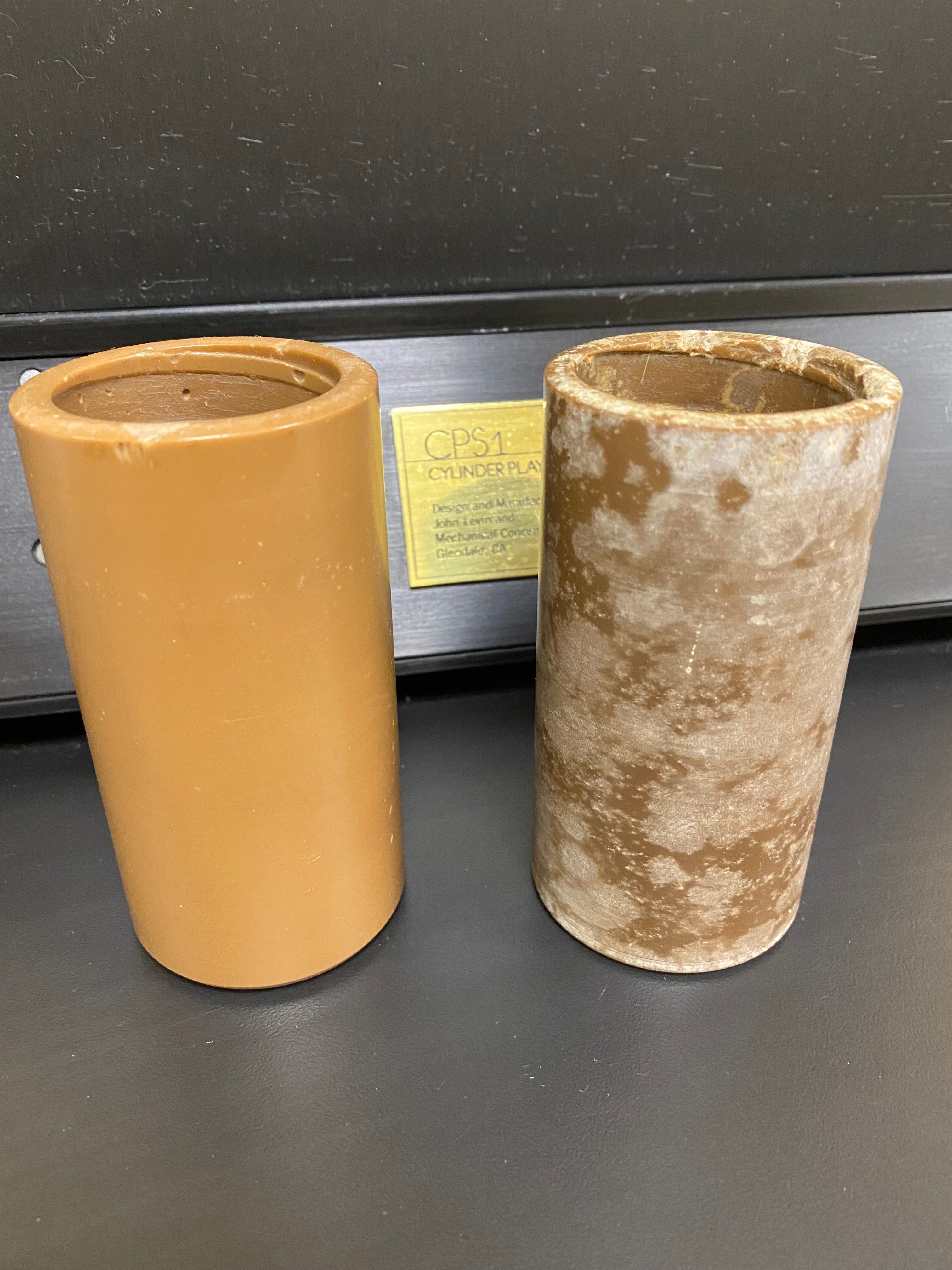 An early wax cylinder that suffered damage from improper storage (right) next to one that fared better (left).