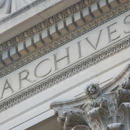 Exterior of the National Archives building zoomed in on the word Archives.