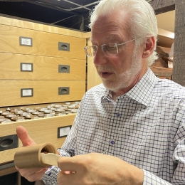 John Levin examines a wax cylinder from his home collection.