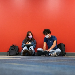Masked students studying in the Library.