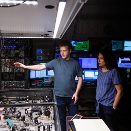 Two people in a science lab looking at equipment