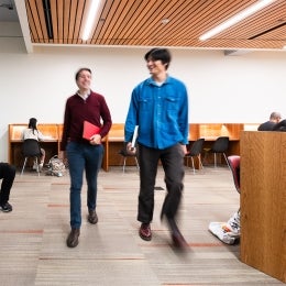 Two patrons walking in Arts Library