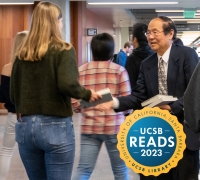 Chancellor Yang handing a UCSB Student a UCSB Reads Book