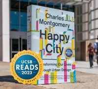 A Happy City Book in front of the library with the UCSB Reads logo