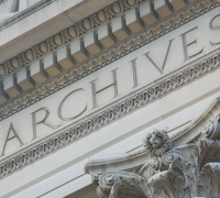 Exterior of the National Archives building zoomed in on the word Archives.