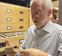 John Levin examines a wax cylinder from his home collection.