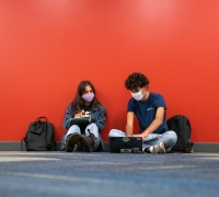 Masked students studying in the Library.