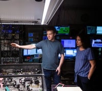 Two people in a science lab looking at equipment