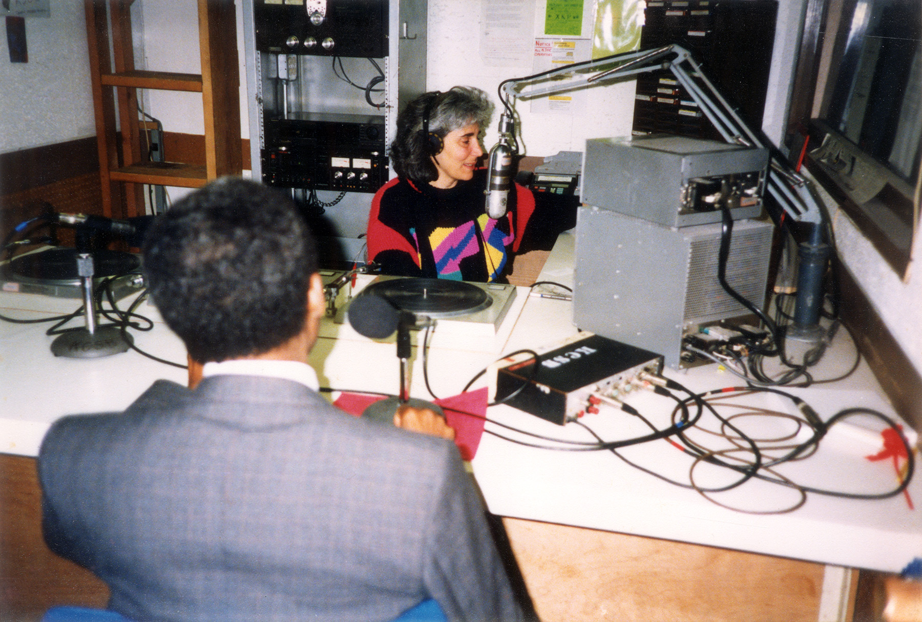 Elizabeth Robinson interviews a guest from Latin America on Third World News Review in the KCSB-FM Radio studio at UCSB, mid- to late 1990s.